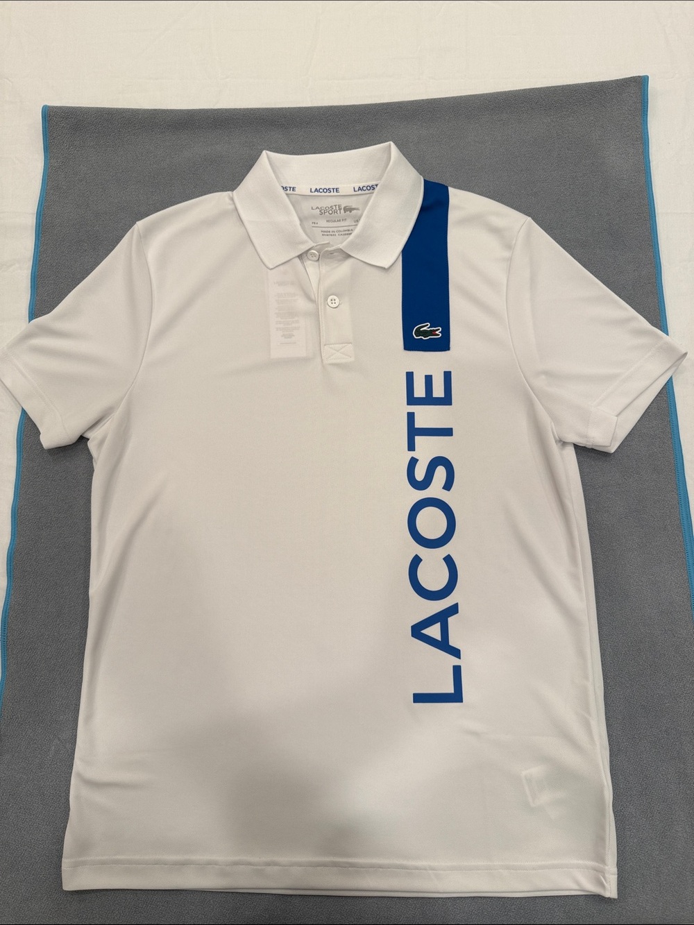 Lacoste White Polo with Bold Blue Vertical Logo